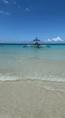 Sunny morning at Boracay's White Beach, outrigger offshore