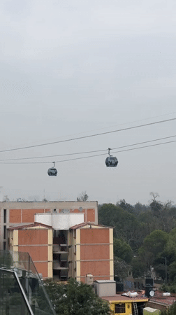 Cable cars operate across Mexico City amid routine daily life