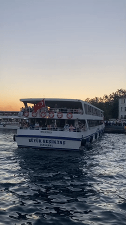 Istanbul waterfront at dusk: ferries, a police boat, and a wedding shoot