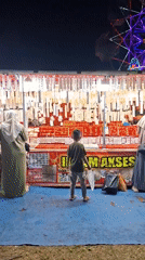 Night market operates in Indonesian village with rides and vendors