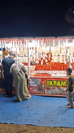 Night market operates in Indonesian village with rides and vendors