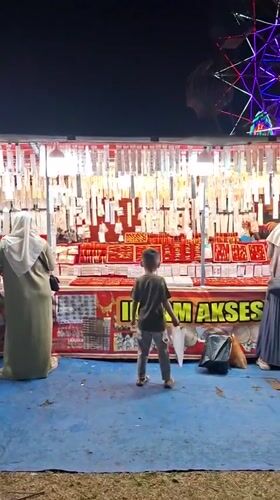 Night market operates in Indonesian village with rides and vendors