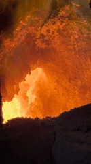 Worker documents molten furnace operations in Belarus industrial facility