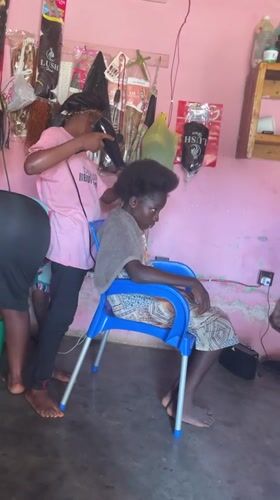 Hair styling session captured at Akwanga salon