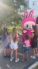 Pink bunny mascot meets a crowd outside Saratov apartment block
