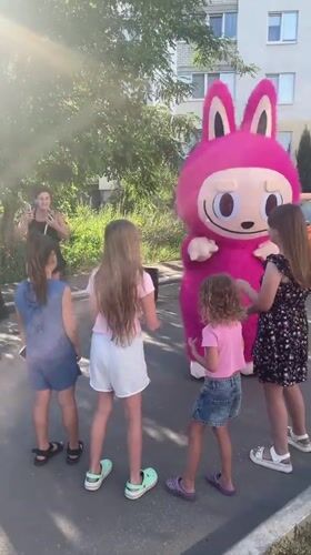 Pink bunny mascot meets a crowd outside Saratov apartment block