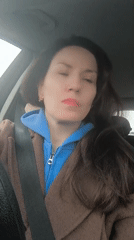 Woman in car, vintage scooter display captured in Riga
