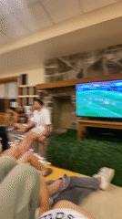Young adults watch soccer game in cozy Washington Township room