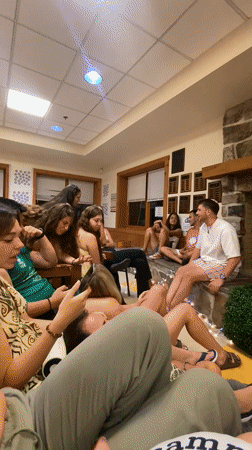 Young adults watch soccer game in cozy Washington Township room