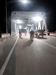 Nighttime traffic flows across Lhokseumawe bridge in Indonesia
