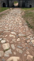 Morning tourists explore Bulgaria's historic Belogradchik Fortress and rock formations