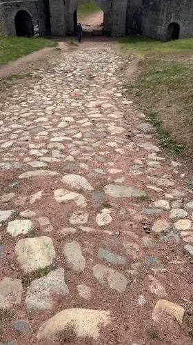 Morning tourists explore Bulgaria's historic Belogradchik Fortress and rock formations