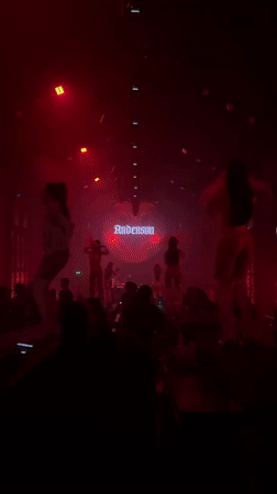 Red-lit nightclub show in Bali with 'Anderson' branding on stage