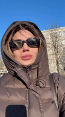 Woman films outdoor selfie video in sunny Riga
