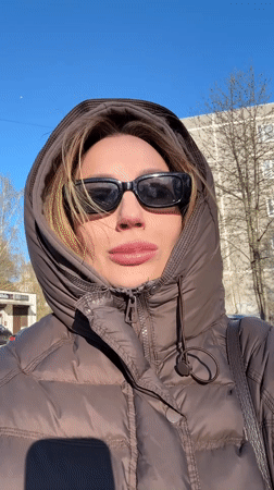 Woman films outdoor selfie video in sunny Riga