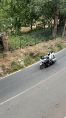 Motorcyclists travel paved road in Asgaour, Morocco