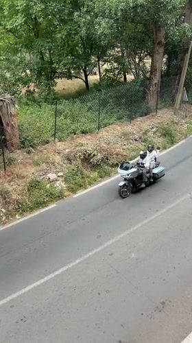 Motorcyclists travel paved road in Asgaour, Morocco