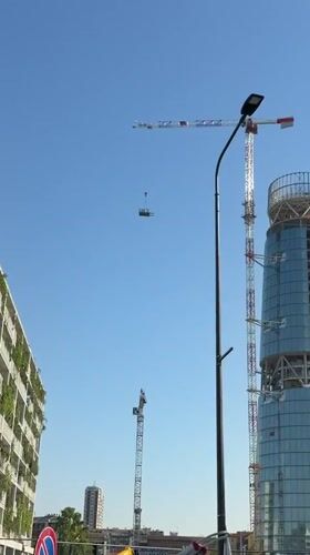 Construction cranes active at Milan skyscraper site Tuesday morning