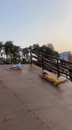 Kids playing on a wooden ramp structure at a Sidoarjo park