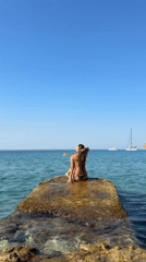 Perched on coastal rocks off Andratx, clear blue Mediterranean ahead.