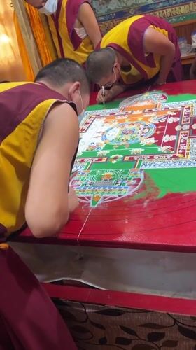 Masked monks create sand mandala at Dharamshala monastery