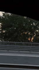 Golden sunset over Riga, framed through a moving car window