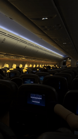 Dimly lit passenger airplane cabin observed over New York