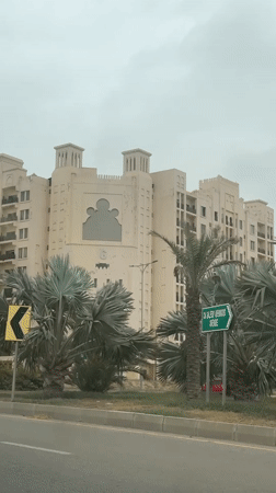 Islamic-influenced multi-story building in Karachi on overcast morning