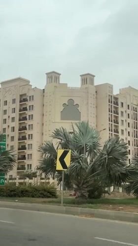 Islamic-influenced multi-story building in Karachi on overcast morning