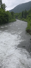 Turbulent river filmed from bridge in Seira, Spain