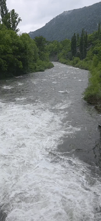 Turbulent river filmed from bridge in Seira, Spain