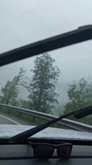 Driver navigates foggy mountain road in snowy conditions near Estosadok
