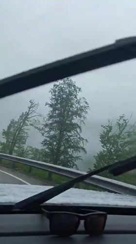 Driver navigates foggy mountain road in snowy conditions near Estosadok