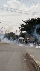 Armed police and smoke on a busy urban street