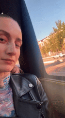Woman gazes from vehicle window in Kryvyi Rih