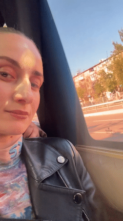 Woman gazes from vehicle window in Kryvyi Rih