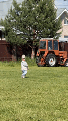 Toddler spotted on lawn with orange tractor in Vysokinichi