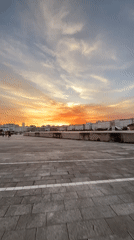 Vibrant sunset illuminates A Coruña cityscape, witnessed from multiple locations
