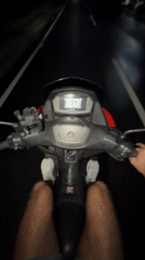 Motorcyclist rides Yamaha through Mengwi at night, speedometer shows 37