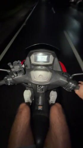 Motorcyclist rides Yamaha through Mengwi at night, speedometer shows 37