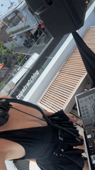 Woman prepares to DJ from balcony in North Kuta