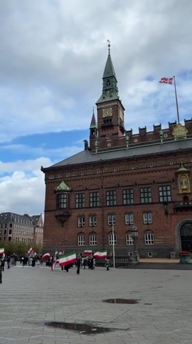 Iranian flags displayed near Danish building, historic ship spotted