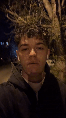 Young man records nighttime selfie video in Sofia streets
