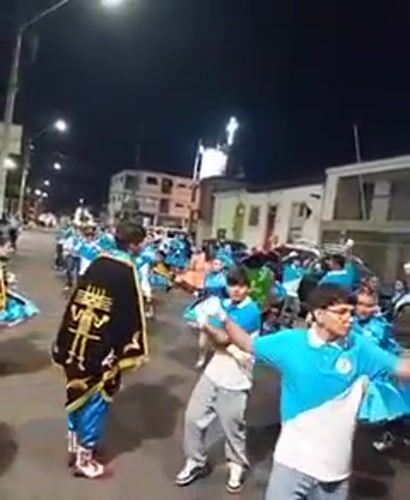 Traditional costume parade with religious imagery occurs in Iquique Chile