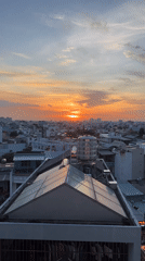 Vietnamese Restaurant Grilling and Urban Sunset Views Captured