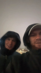 Two men filmed speaking on rainy Perm street