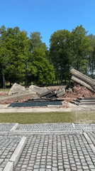 Visitor documents crematorium ruins at Brzezinka concentration camp site