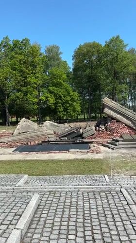 Visitor documents crematorium ruins at Brzezinka concentration camp site
