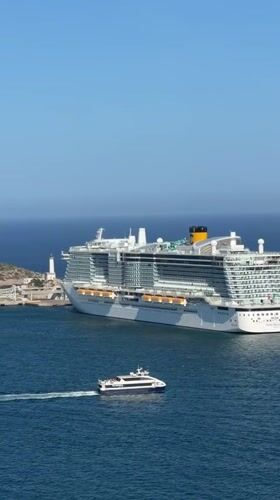 Tourists capture scenic Ibiza coastline views from historic fortifications