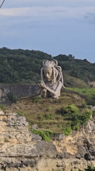 Stone statue with tentacled headdress observed in Nusa Penida